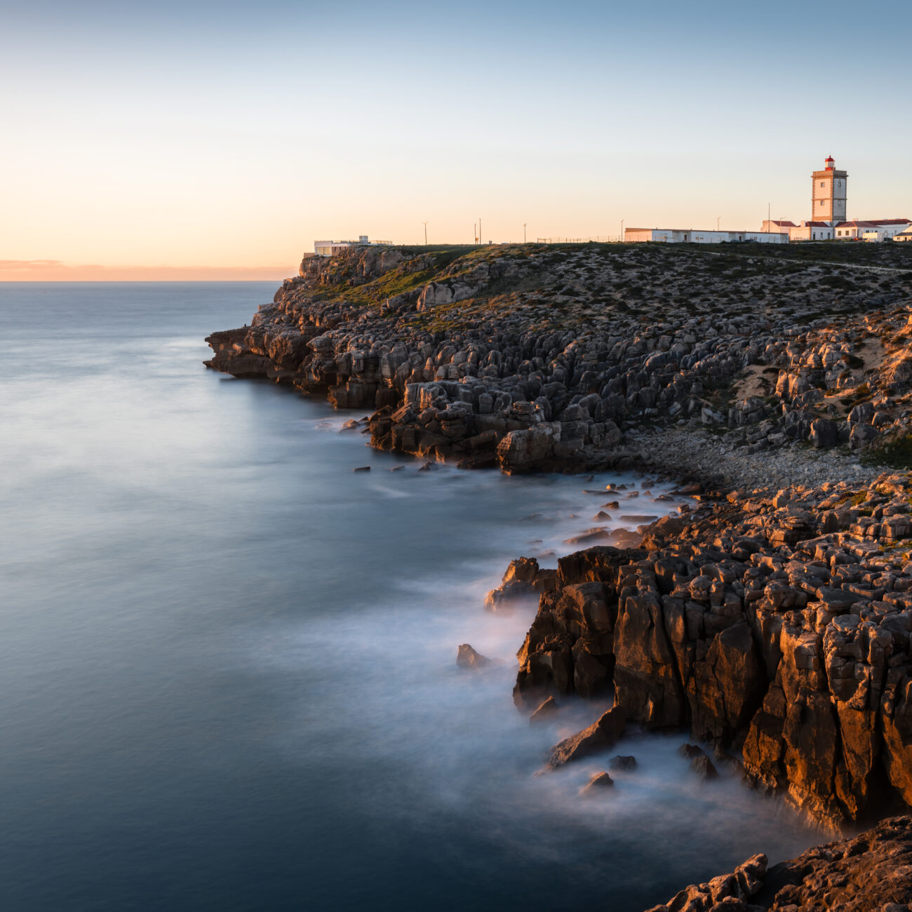 THE EDGE OF THE CONTINENT
    Witness the dramatic majesty of Cabo Carvoeiro’s unique rock formations and the iconic lighthouse, standing guard over the rugged Atlantic horizon.